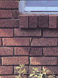 Exterior stress cracks in brick veneer indicate house leveling problems.