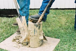 This photo also shows the workers removing the soil from the belling tool.