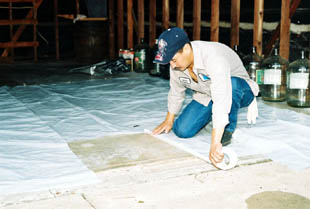 This worker is marking the area where a hole will be dug for an interior Bell Bottom Pier.