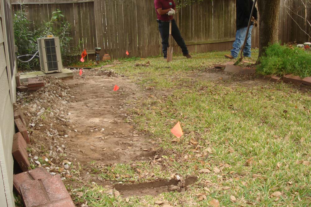 Clearing the area where the trench will be dug for the root barriers / barricades - Foundation Repair in Plano