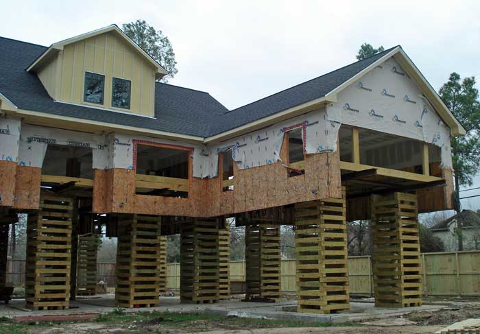 This house will rest on wood blocks until the new concrete walls and columns are constructed.