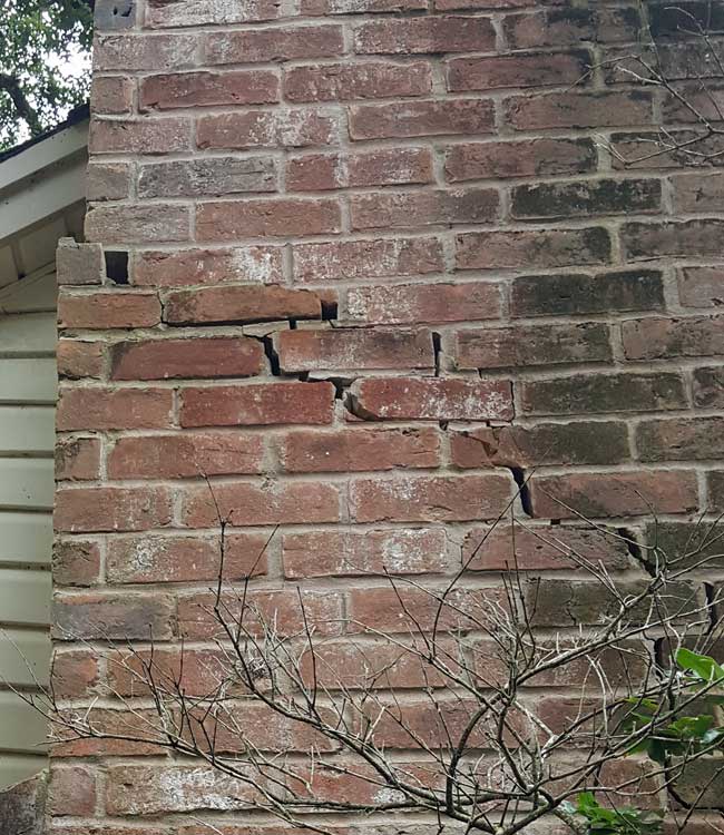 This fireplace damage demonstrates the powerful forces of soil movement under the concrete slab foundation.