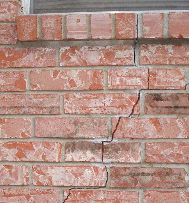 Photo of a home's exterior brick cracks due to foundation movement or failure.