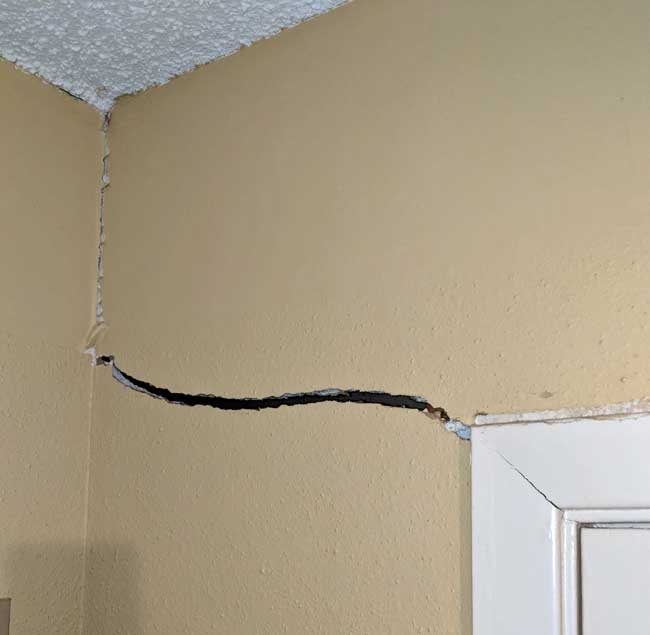 Movement of the home's slab foundation often results in interior sheetrock cracks around doors and windows.