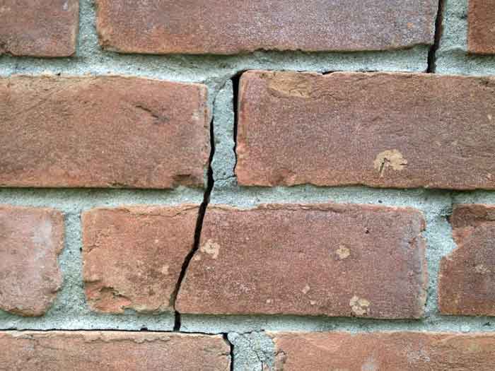Exterior bricks will crack as shown in the photo when concrete slab foundations move.