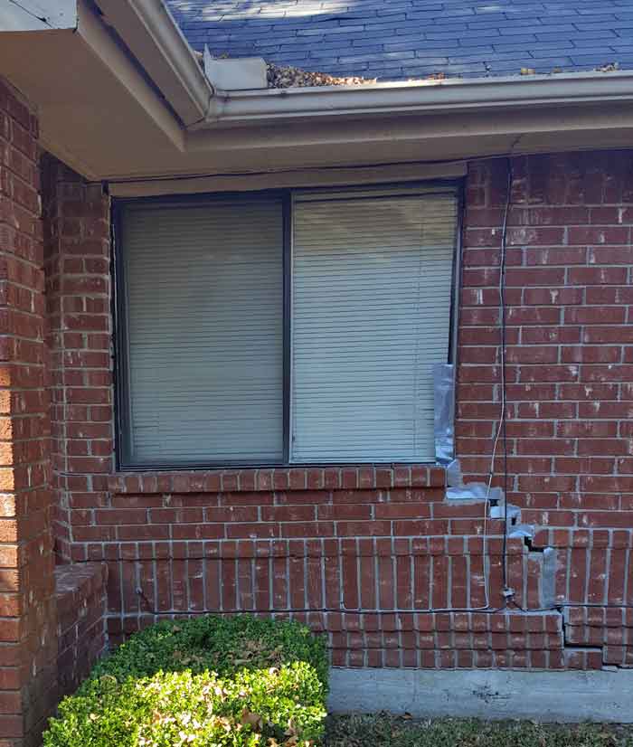 This Fort Bend County house has experienced foundation movement which has created large cracks and gaps in the exterior brick walls.