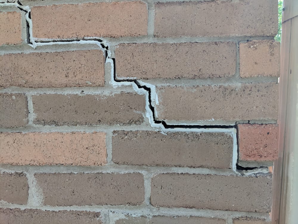 Exterior Brick Cracks are caused by the movement of the  foundation's concrete slab.