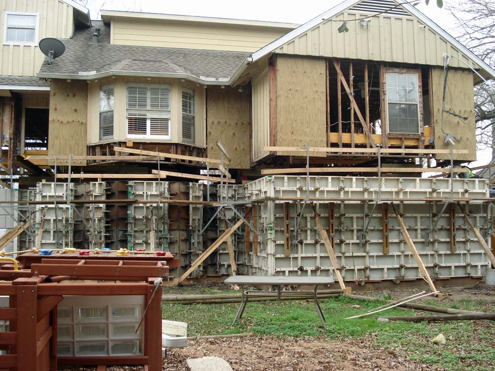 Construction of concrete foundation walls to elevate house above 500 year floodplain.