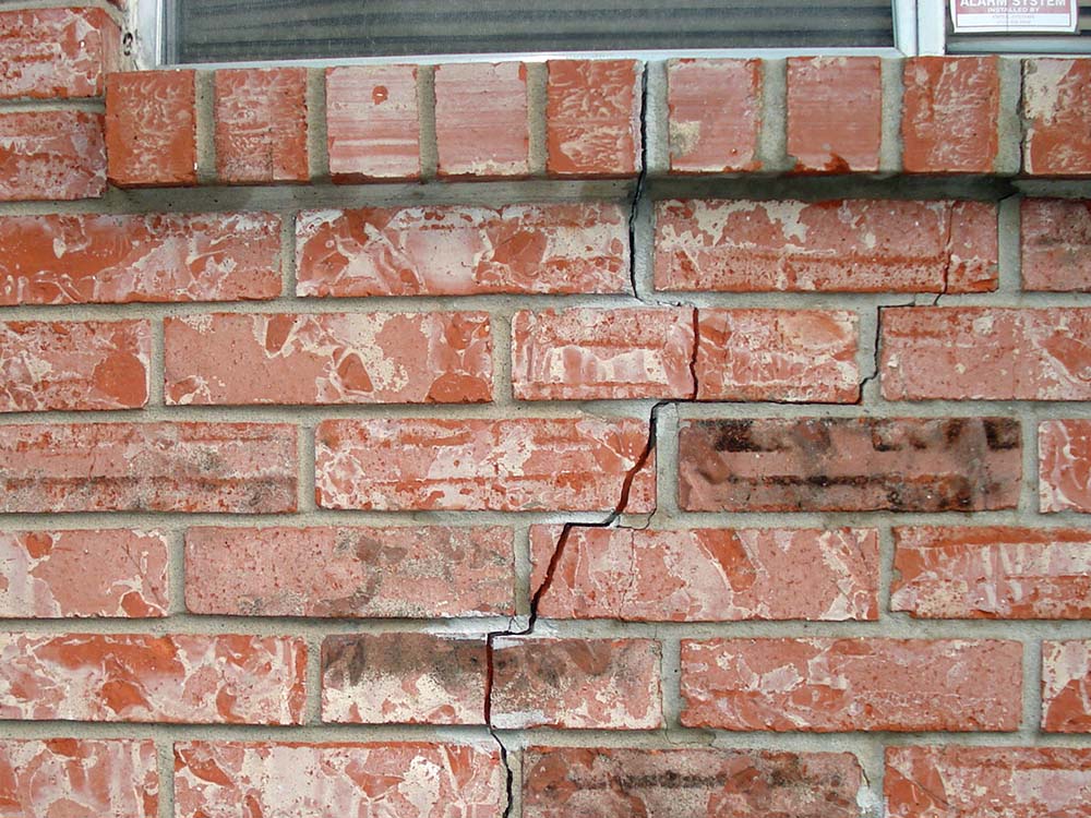 Foundation movement has cracked the exterior brick wall