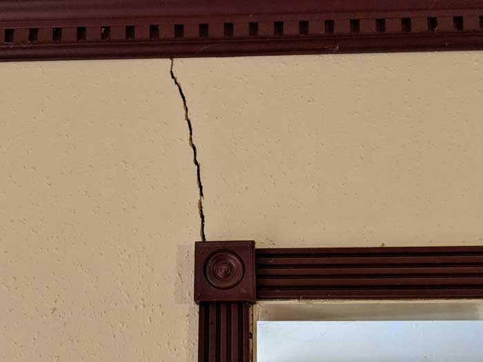 Soil movement has cracked the home's slab foundation and resulted in additional damage to the home's interior walls.