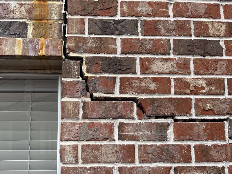 The clay soils under the front of the house settled and cracked the slab, interior walls, and exterior walls.